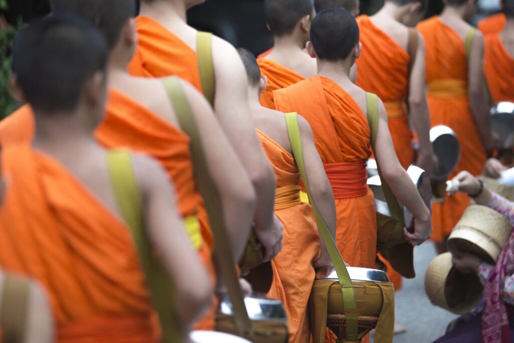 Buddhist Monks On Everyday Morning Traditional Alms Giving In Luang Prabang, Laos.