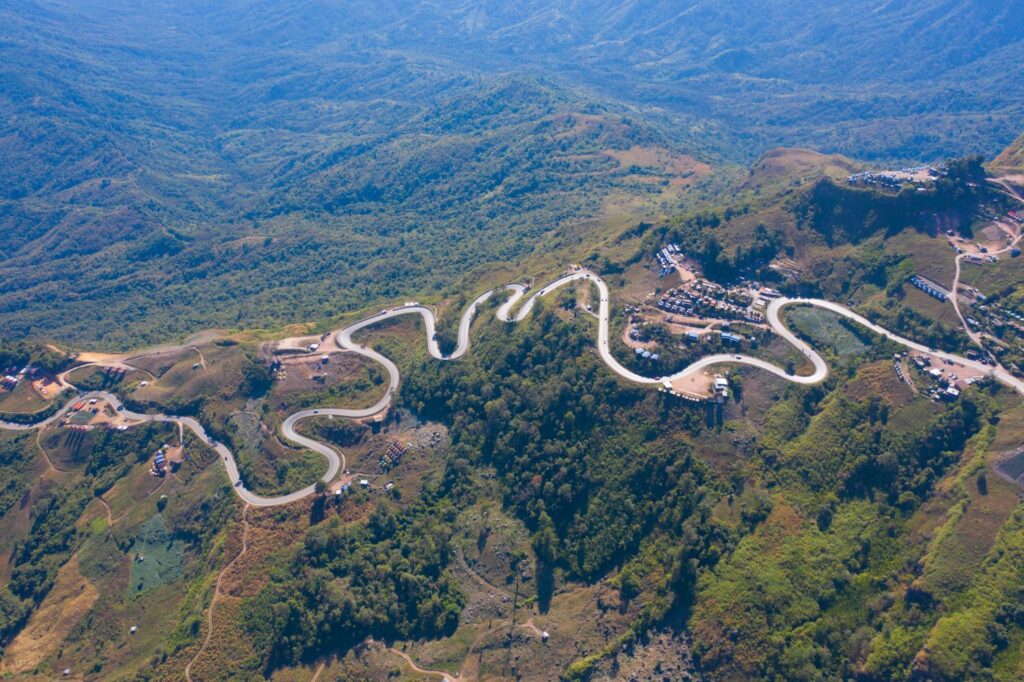 Aerial View Of Cars Driving On Curved, Zigzag Curve Road Or Street On Mountain Hill With Green Natural Forest Trees In Rural Area Of Phu Tub Berk, Phetchabun, Thailand.