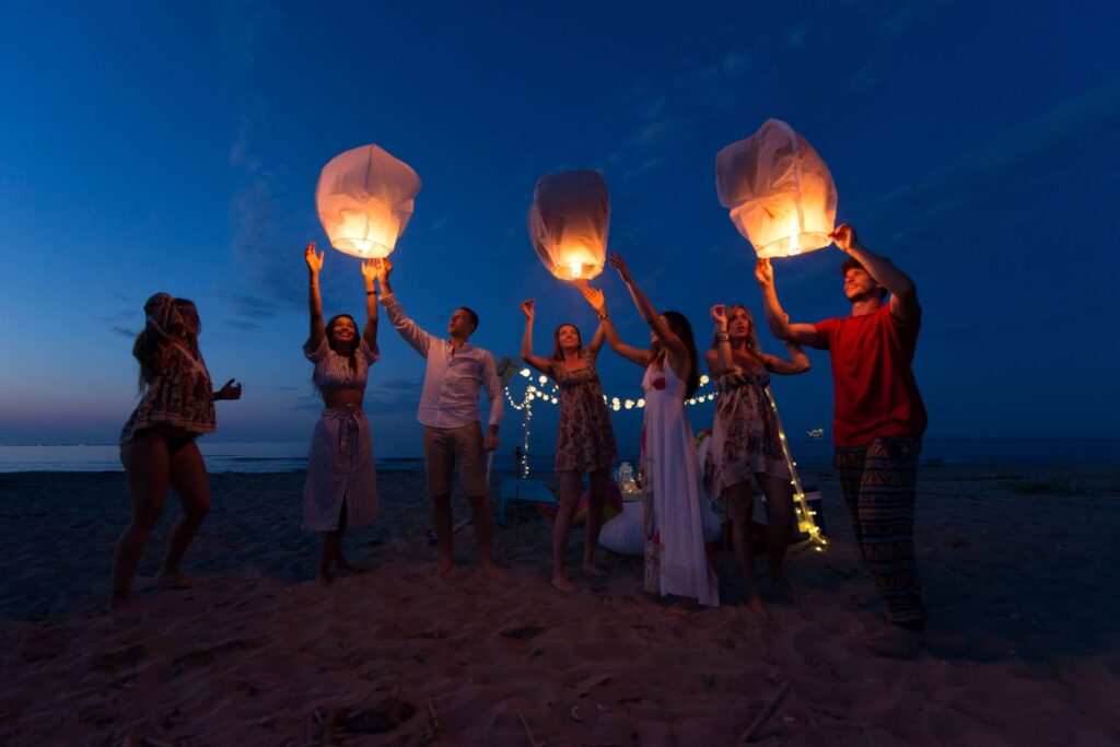 Group Of Friends Lighting Lanterns